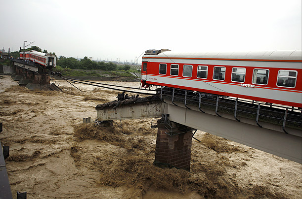 The Space Between

The two ends of a train remain after floods destroyed the bridge beneath it in Guanghan, China.