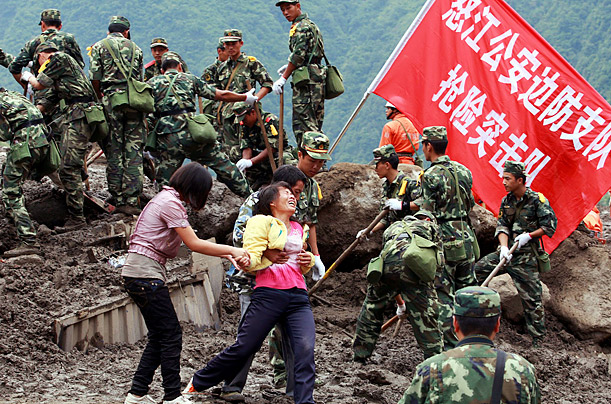 Grief

A woman whose relatives were killed during a landslide cries while being helped off the disaster site in Puladi, China.