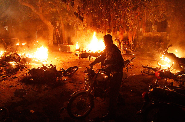 Fiery Protest

A policeman removes his motorcycle as angry protesters burn a vehicle in reaction to a bomb attack on a Shi'ite Muslim procession in Lahore, Pakistan.
