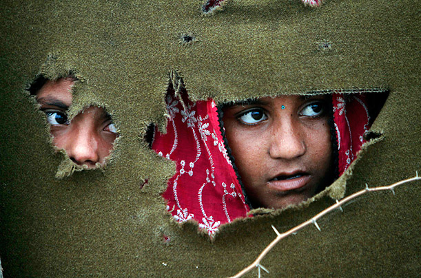 Looking Forward

Pakistani flood survivors look out from their make-shift tent after fleeing their village in Sajawal, Pakistan. Hundreds of thousands of Pakistanis fled floodwaters after the Indus River smashed through levees.