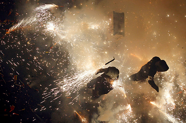 Lit Up

A group of coeters, or firework lighters, strike rockets covered with fireproof clothes during the traditional 'Corda de Paterna' festivals held in Paterna, Spain.