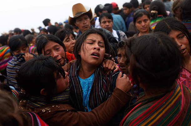 A relative cries during the funeral of 13 victims of a landslide in the
village of Parrasquin in Nahuala, Guatemala.