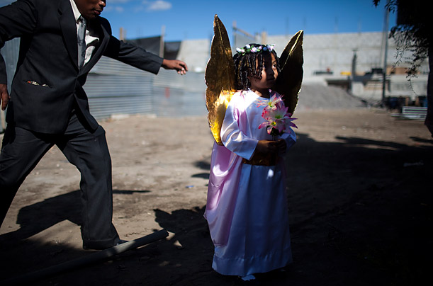 A girl dressed as an angel on the day of the Virgin of the Immaculate Conception celebrations in Ciudad Vieja, Guatemala.