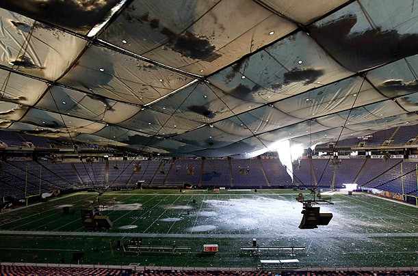 Snow lies on the field of the Minneapolis Metrodome after the roof collapsed from a large accumulation of snowfall.