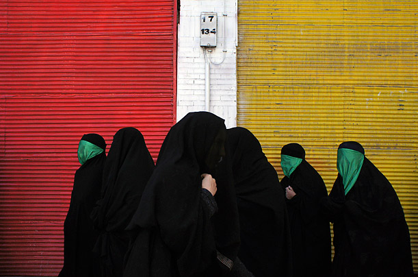 Women cover their faces with green scarves, symbols of the Imam Hussein family, during a Shi'ite Ashura religious festival in Khorramabad, Iran. Iman Hussein was the grandson of