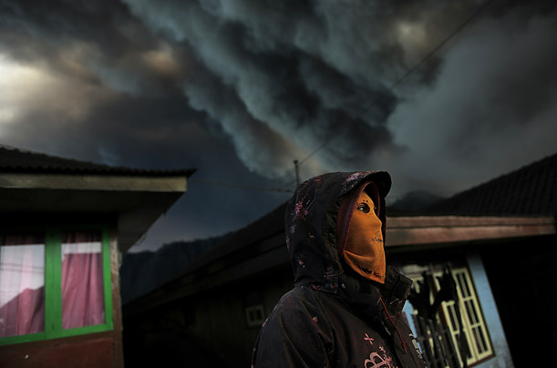 An Indonesian man wears a mask to avoid inhaling ash from Mount Bromo, an active volcano, in the village of Cemoro Lawang near Indonesia's central Java island.
