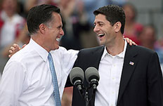 Republican presidential candidate, former Massachusetts Gov. Mitt Romney (L) and U.S. Rep. Paul Ryan (R-WI) (R) wave as Ryan is announced as his running mate aboard the USS Wisconsin Aug. 11, 2012 in Norfolk, Va.