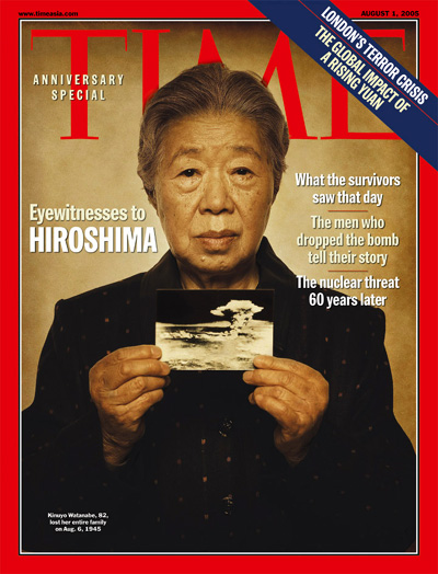 A survivor of Hiroshima holds a picture of the mushroom cloud resulting from the bomb.