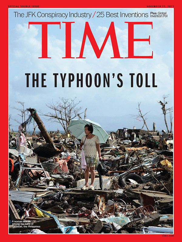 Photo of a woman standing among the ruins of Tacloban, the Philippines