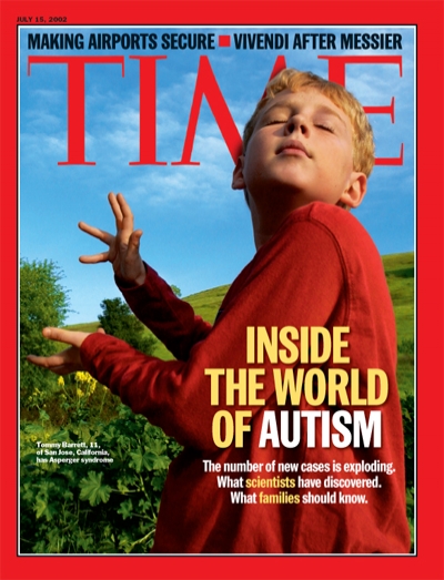 A photograph of an autistic boy in a garden.