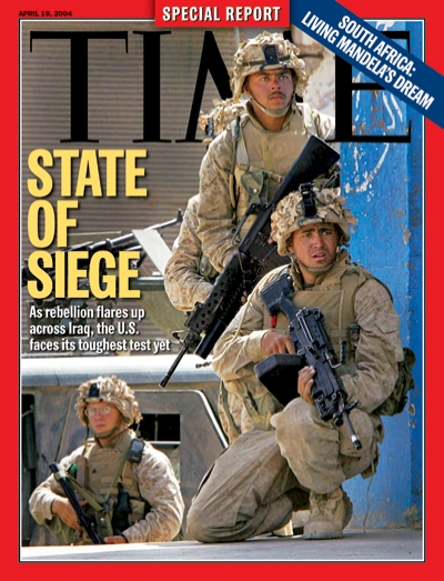 U.S. soldiere in Iraq moving cautiously down and urban street re recent upsurge of violence.