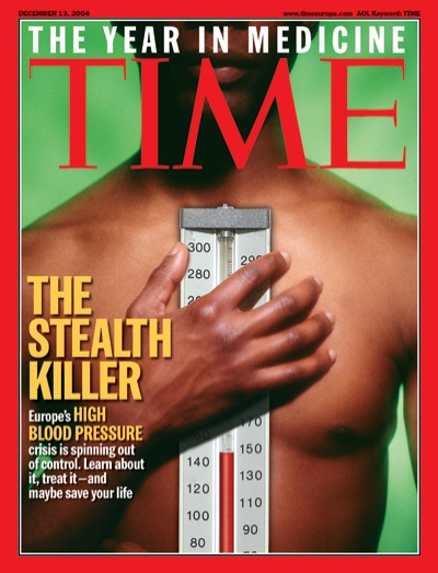Picture of a man holding a thermometer to his bare chest.
