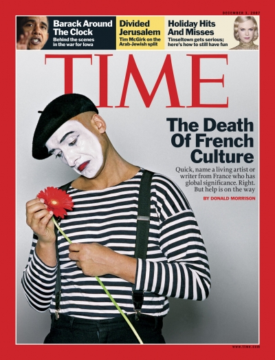 Photo of a sad mime looking at a flower.