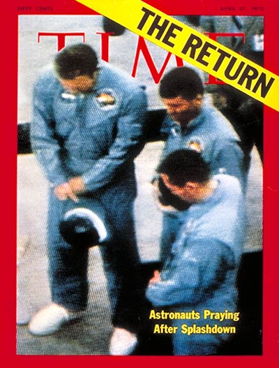 Returning Apollo 13 astronauts, Jim Lovell, Fred Haise and John Swigert praying after splashdown pickup