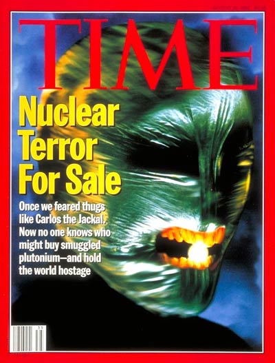 Nuclear Terror for Sale.  Green masked face with glowing sphere in teeth.
