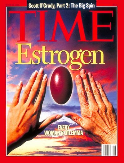 Every Woman's Dilemma.  Youthful left hand and aging right hand with estrogen pill framed between them against sunset sky