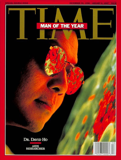 AIDS researcher Dr. David Ho, TIME's Man  the Year, examines enlarged image of a T cell infected with the AIDS virus; electron micrograph from NIBSC/SPL-Photo Researchers.