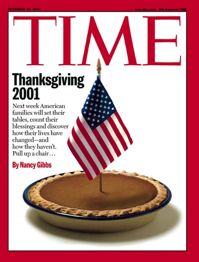 A pumpkin pie with an American flag in represents the Thanksgiving holiday. No Photo Credit given.