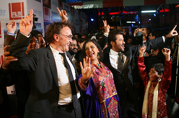 Boyle dances with Slumdog cast members at the film's premiere in Mumbai.

