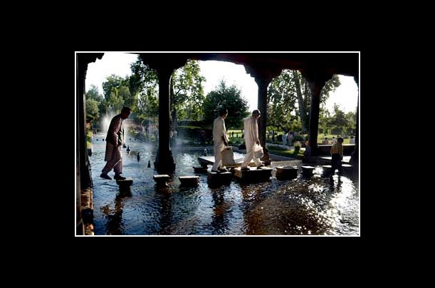 Kashmiris walk through Moghul gardens in Srinagar, the summer capital of the disputed Indian state of Jammu and Kashmir