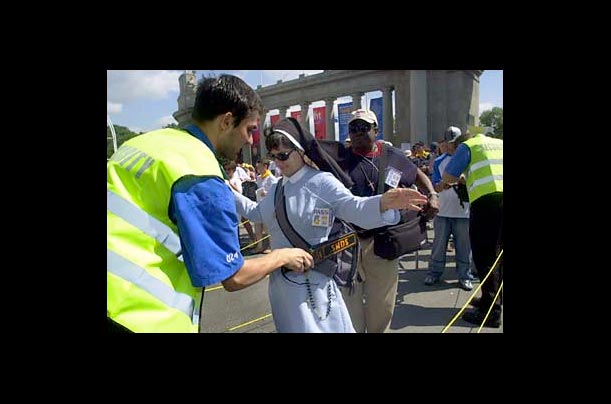 Sister Marla Marie of New York City gets checked at a security checkpoint at Exhibition Place as she arrives for World Youth Day in Toronto, Canada