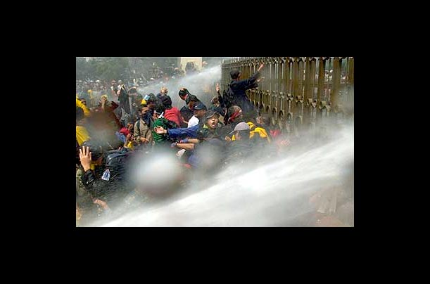 Indonesian police fire water cannon to disperse student protesters gathered at the gates of the parliament in Jakarta to demand sweeping constitutional reforms