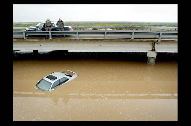 department of public safety troopers inspect a submerged vehicle on interstate 20 in texas