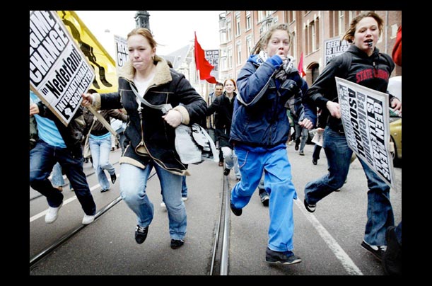 protesters run through a street in amsterdam to protest the dutch government's plans to expel 26,000 failed asylum seekers protesters run through a street in amsterdam to protest the dutch government's plans to expel 26,000 failed asylum seekers