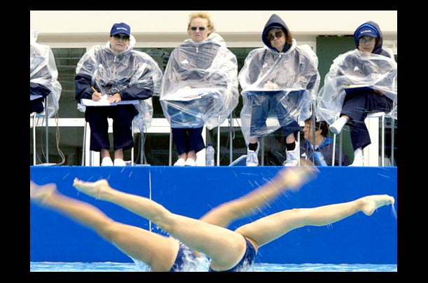 judges watch a mexican synchronized swimming duo perform during the olympic games qualification tournament