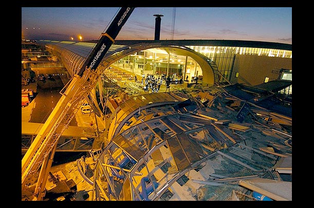 Firefighters search debris after a section of the roof collapsed at Charles de Gaule airport in Roissy, France