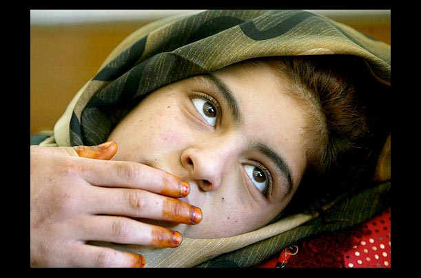 Moza Rikad lies injured in a hospital in Ramadi, Iraq after U.S. helicopters fired at her stepbrother's wedding party