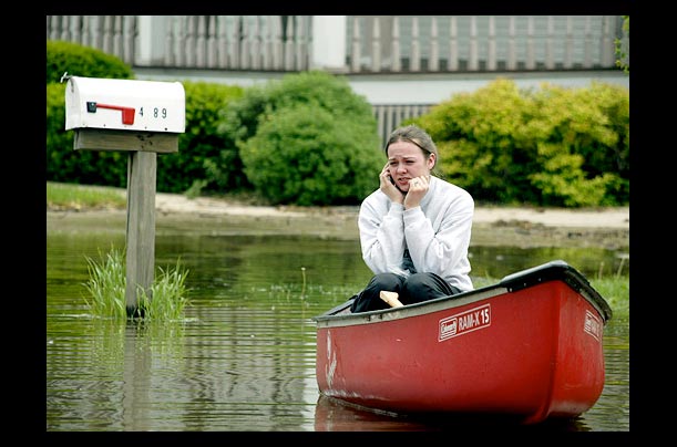 Jeanine Hiett runs errands in her canoe in Gurnee, Illinois a week after heavy rains flooded the Des Plaines River