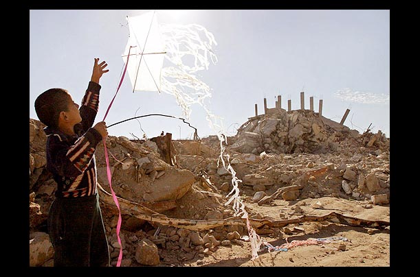 A young boy plays near his destroyed house in the al-Brazil area of the Rafah refugee camp, southern Gaza Strip A young boy plays near his destroyed house in the al-Brazil area of the Rafah refugee camp, southern Gaza Strip
