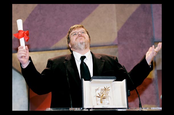 Director Michael Moore holds his Palme d/Or award at the 57th Cannes Film Festival for his film 