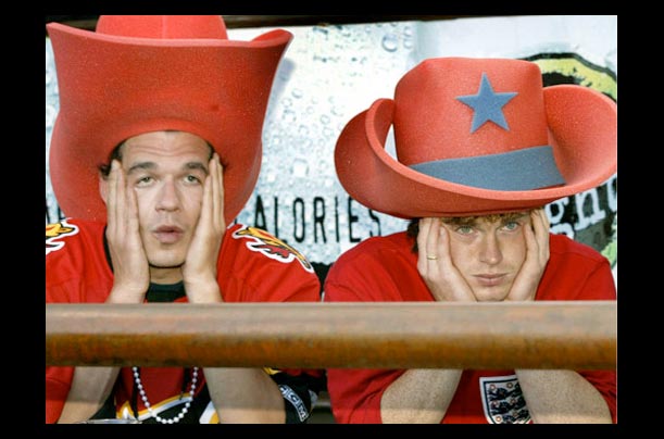 Calgary Flames fans Rich McAuley, left, and John Leith react to the team losing the NHL Stanley Cup final to the Tampa Bay Lightning after watching the game in Calgary