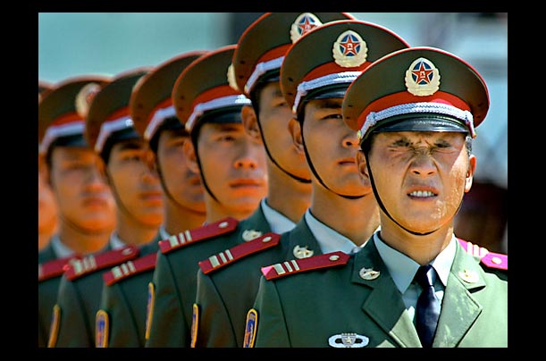 a soldier of the people's liberation army PLA squints during a parade in hong kong for its 77th anniversary