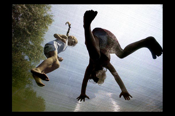 Two Turkish girls jump on a trampoline during the Tourism festival in Masaukiye