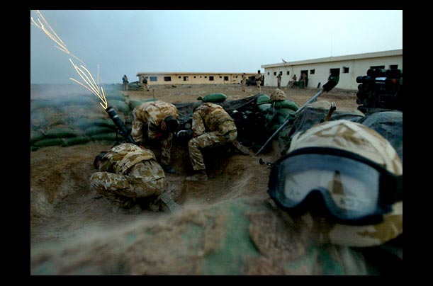 A British mortar team fires a phosphorus flare during early morning perimeter checks at Camp Dogwood, 20 miles southwest of Baghdad