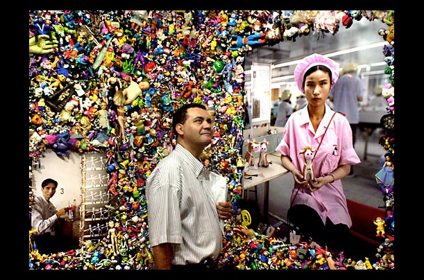 A visitor takes in 'The Real Toy Story' exhibition by photographer Michael Wolf during its opening in Hong Kong