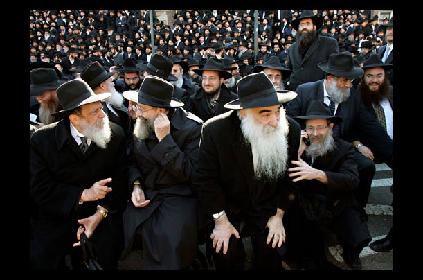 Lubavitch rabbis in traditional Hassidic garb line up outside their headquarters in Brooklyn