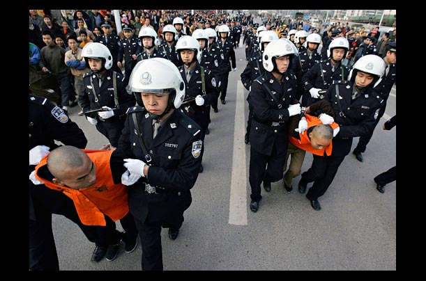 Chinese police escort convicted murderers to a public sentencing in Chongqing, China