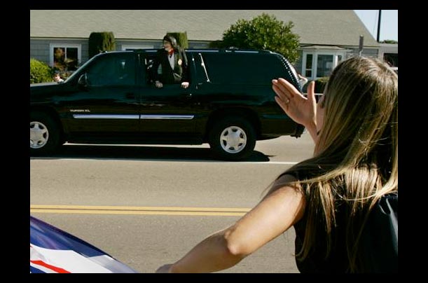 michael jackson leans out of the window of his suv to wave to his fans in santa barbara county