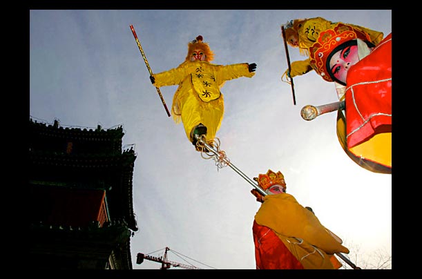 Child performers suspend themselves in the air during a show at Beijing's Dongyue Temple for Chinese New Year