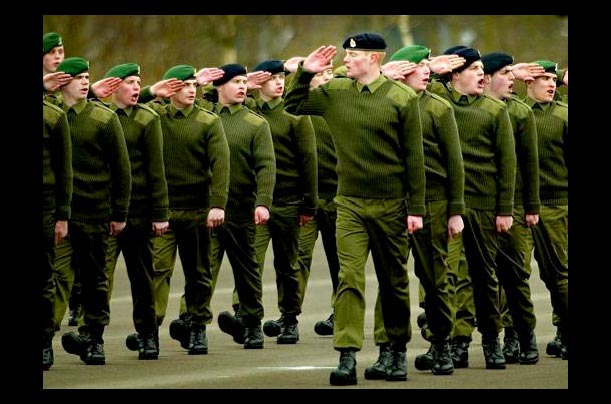 A young recruit turns the wrong way during a salute during basic training at Britain's Army Training Regiment near Winchester