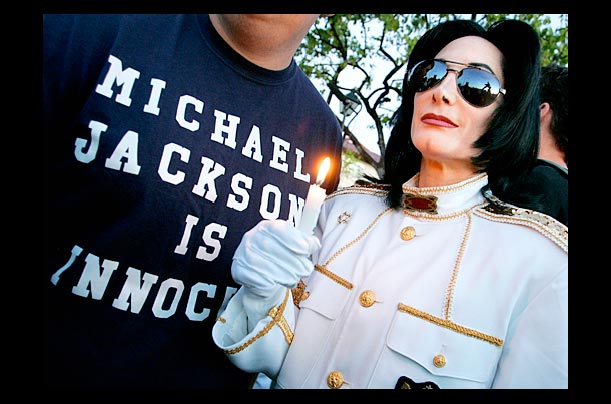 Michael Jackson fan Dev Gregory holds a candle during a rally to support the singer at the Santa Barbara County courthouse