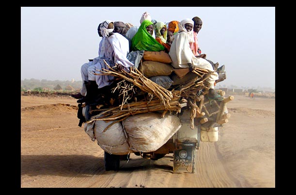 Internal displaced Sudanese sit on a vehicle with their belongings as they travel inside Aboushouk camp in Darfur Internal displaced Sudanese sit on a vehicle with their belongings as they travel inside Aboushouk camp in Darfur