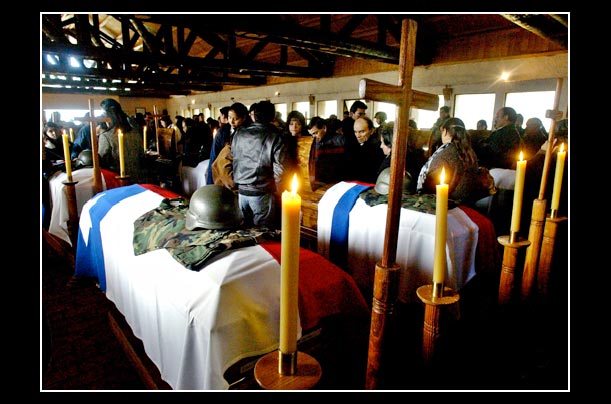 Caskets of dead soldiers lie inside the army church in Los Angeles, Chili, south of Santiago