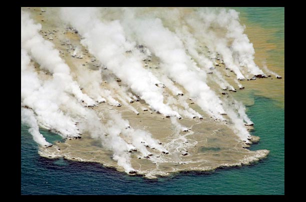 An underwater volcano erupts with a massive column of water vapor in the Pacific Ocean near Minami Iwojima Island