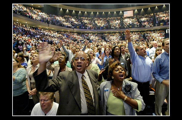 Members of the Lakewood Church worship at the grand opening of a new facility in Houston