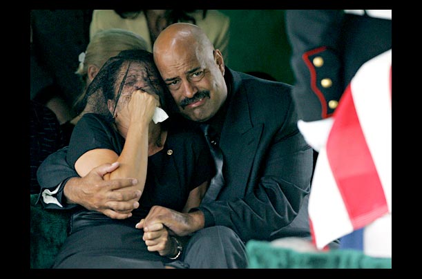 Mary Williams and Kevin Gutrhie comfort eachother in Columbus, Ohio at the funeral of her son Cpl. Andre Williams